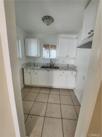 a kitchen with stainless steel appliances a sink and cabinets