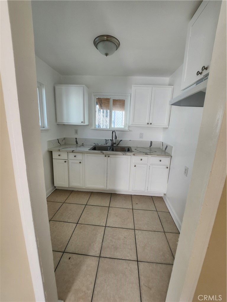3717 West Imperial Highway, Unit 10 Inglewood, CA 90303 - Photo 4 of 5 a kitchen with stainless steel appliances a sink and cabinets