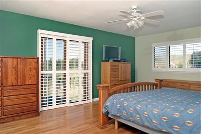 3688 Roblar Road Petaluma, CA 94952 - Photo 6 of 10 a bedroom with a large bed and a chandelier