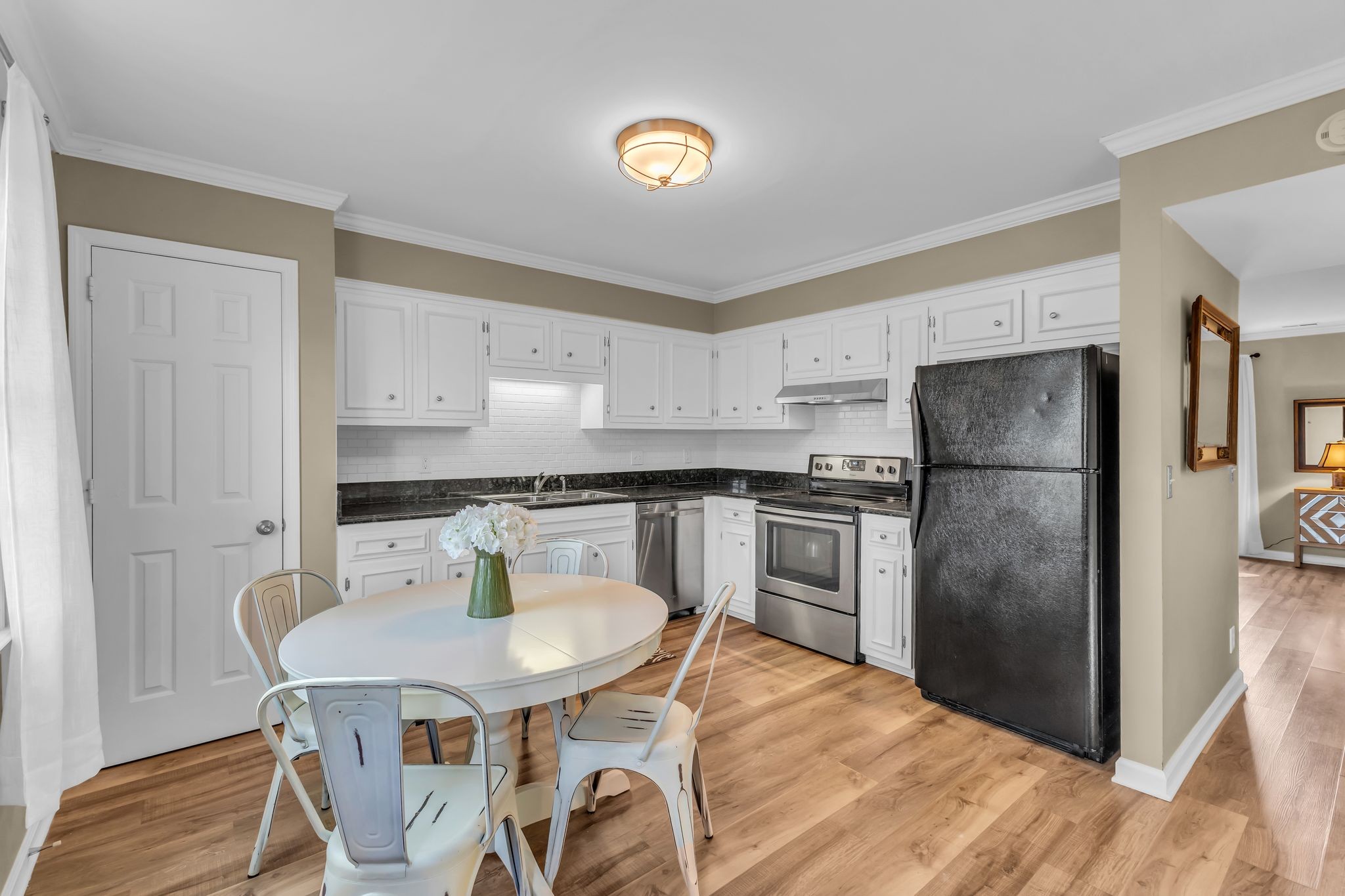 705 Fox Ridge Drive Brentwood, TN 37027 - Photo 13 of 26 a kitchen with stainless steel appliances kitchen island granite countertop a refrigerator a stove a sink dishwasher with a dining table and chairs