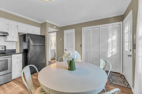 a kitchen with a table and stainless steel appliances