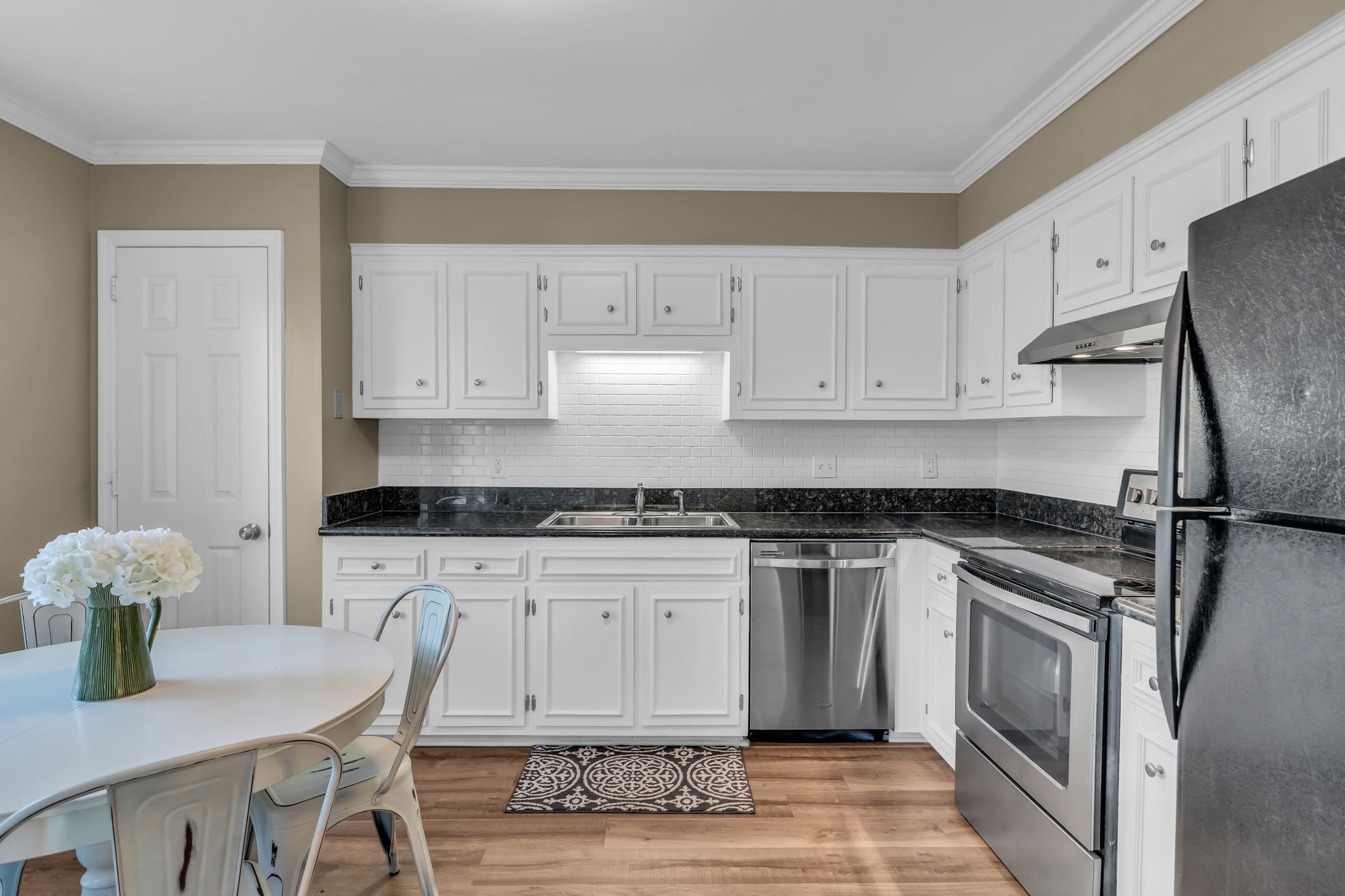 705 Fox Ridge Drive Brentwood, TN 37027 - Photo 15 of 26 a kitchen with stainless steel appliances granite countertop a stove a sink dishwasher and cabinets with wooden floor