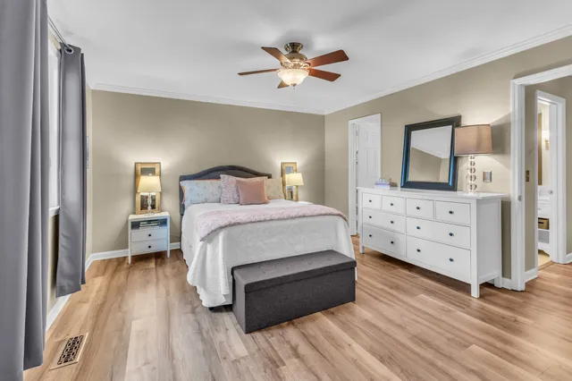 a bedroom with a large bed and a chandelier
