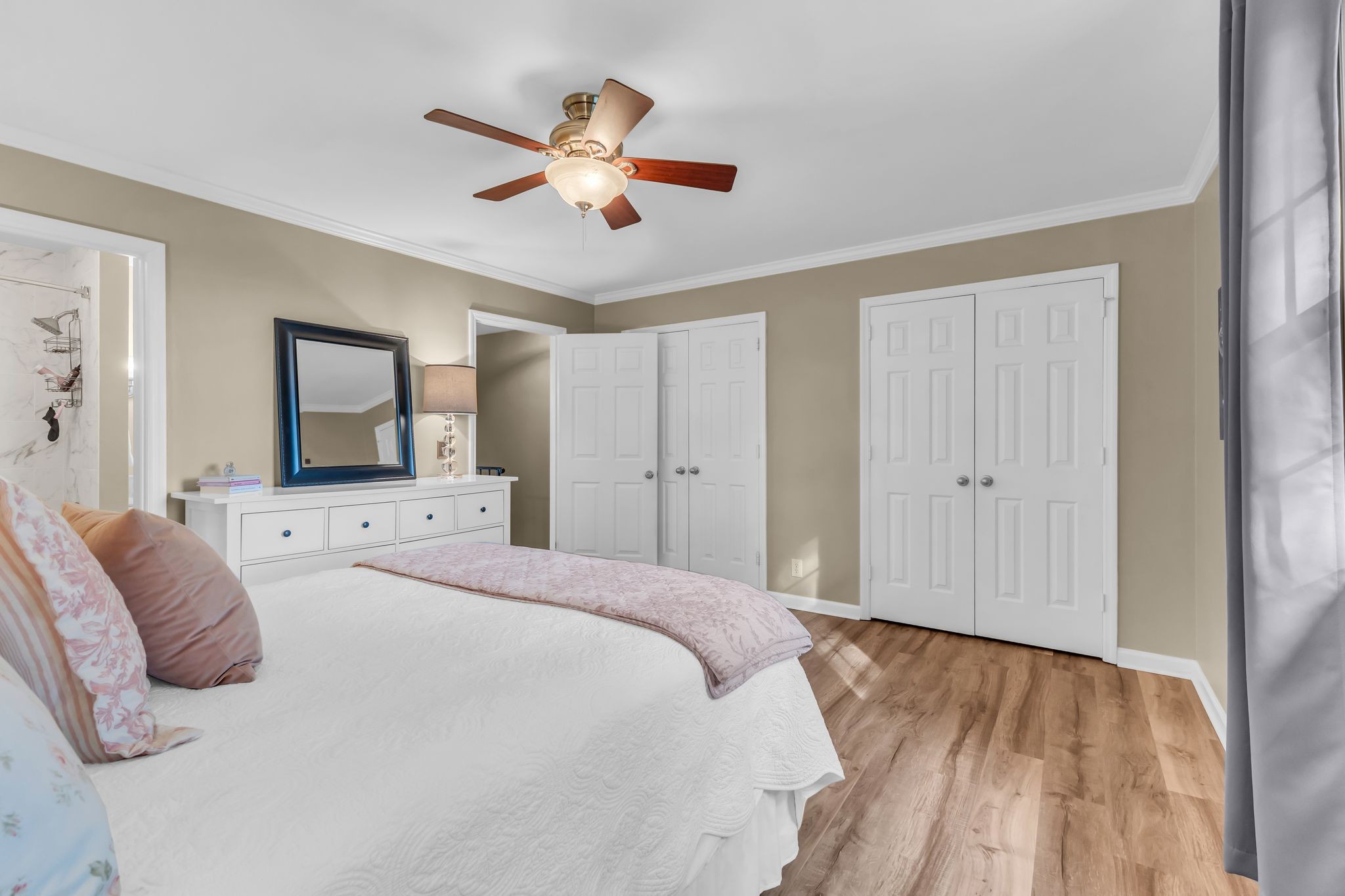 705 Fox Ridge Drive Brentwood, TN 37027 - Photo 22 of 26 a bedroom with a large bed and a chandelier