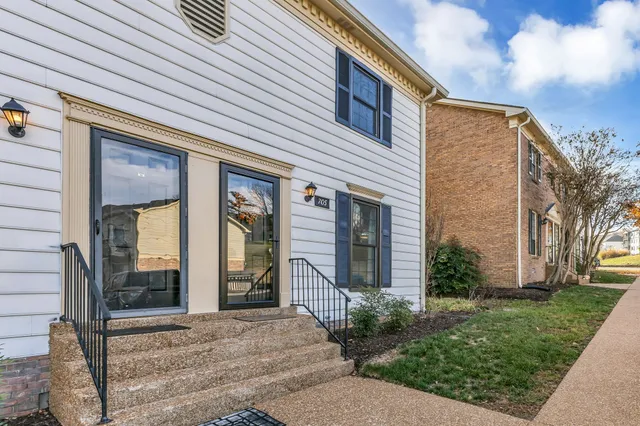 a view of a brick house with a large windows