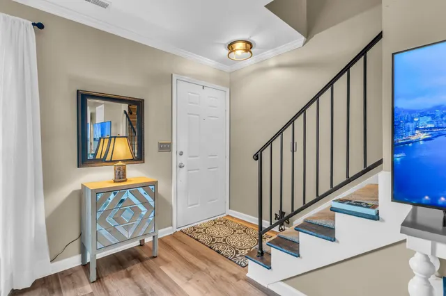 a view of an entryway with wooden floor