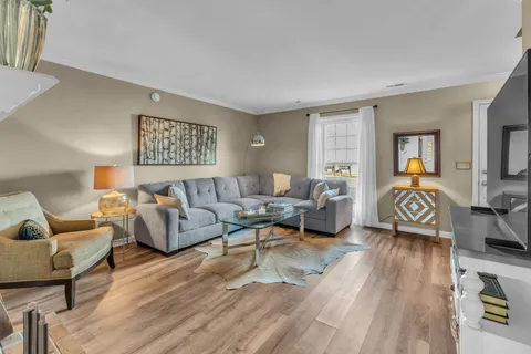 a living room with furniture and a wooden floor