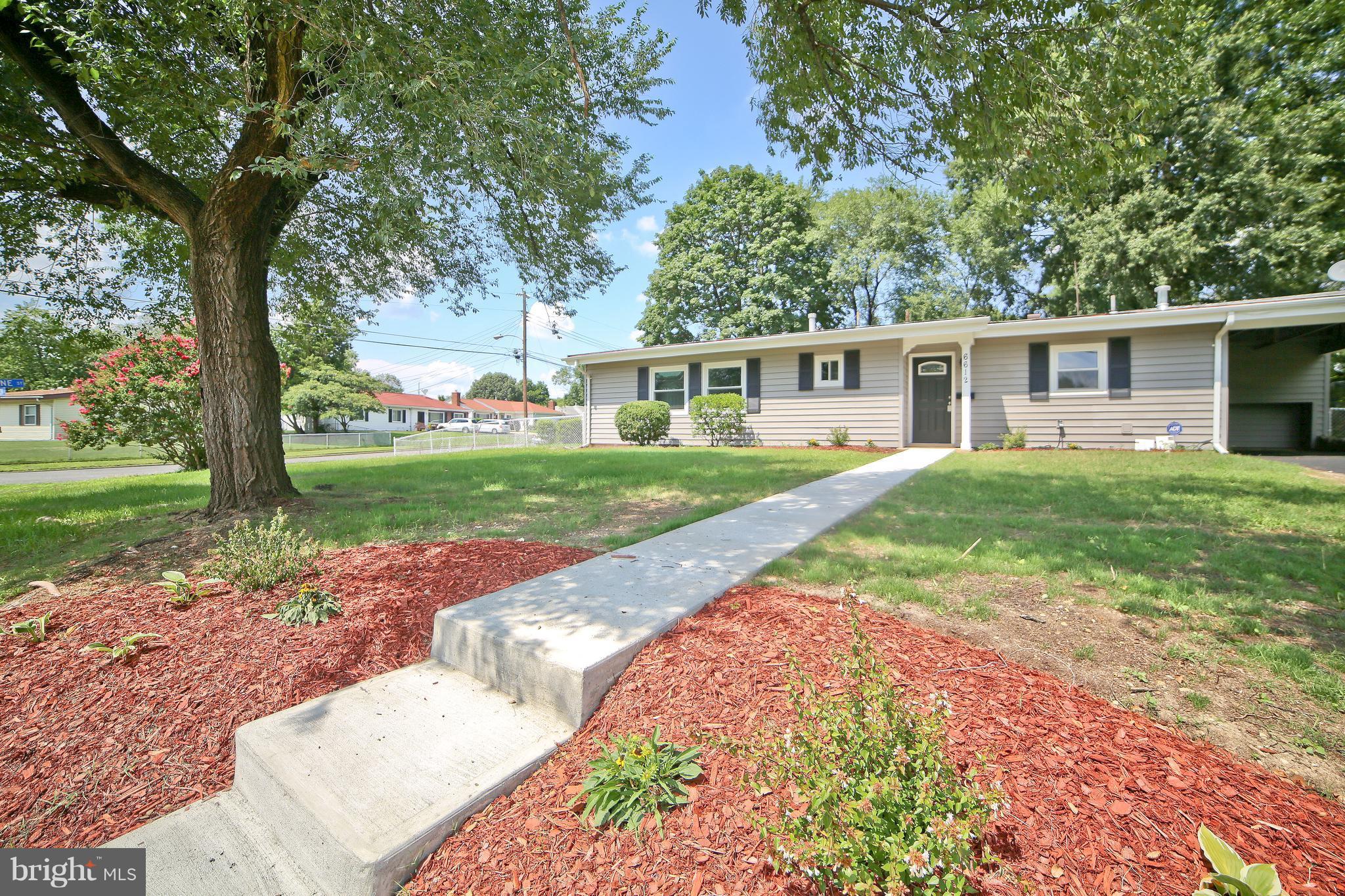 6612 Cimarron Street Springfield, VA 22150 - Photo 2 of 30 front view of a house with a yard