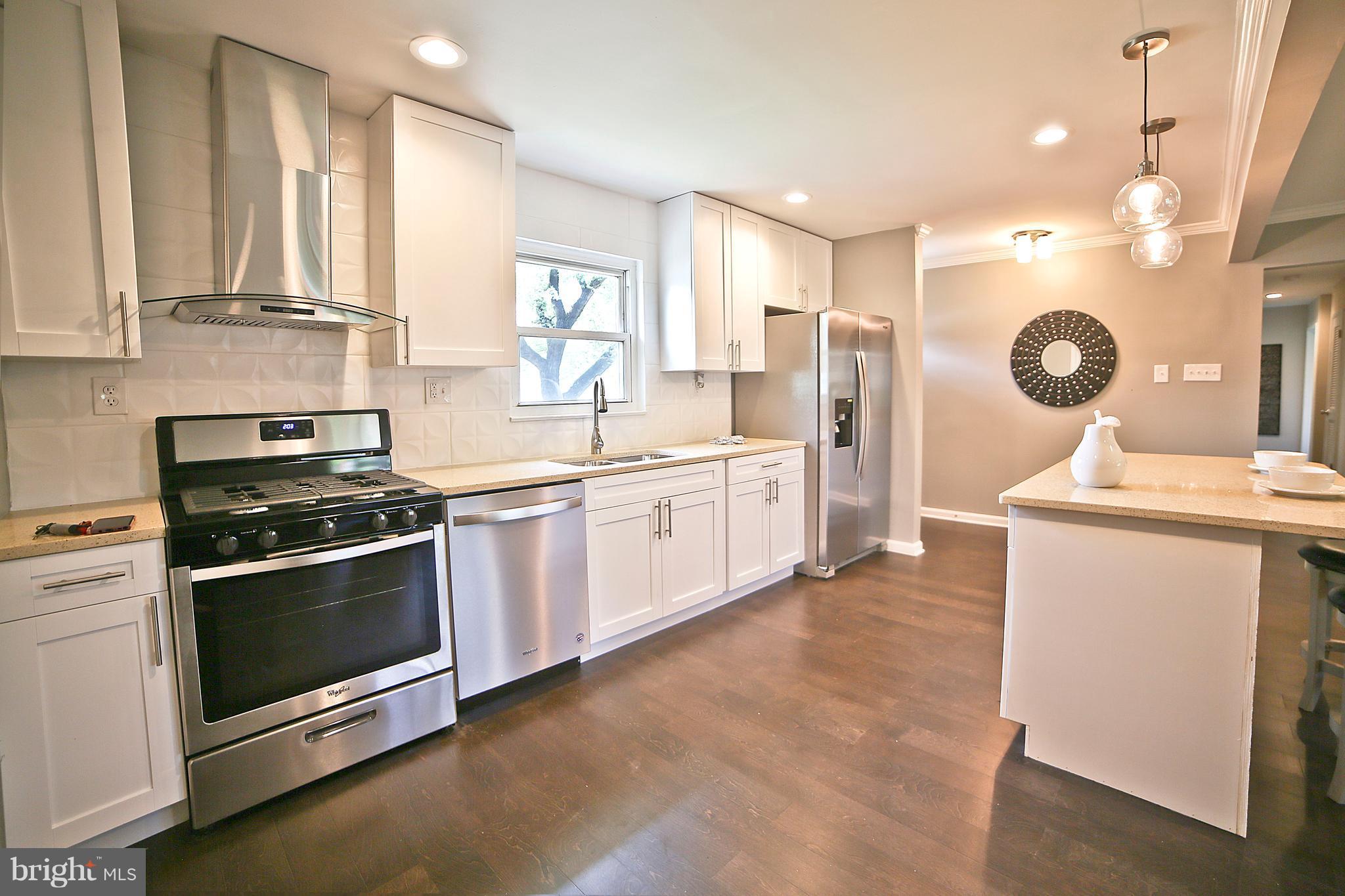 6612 Cimarron Street Springfield, VA 22150 - Photo 10 of 30 a kitchen with a stove oven and sink