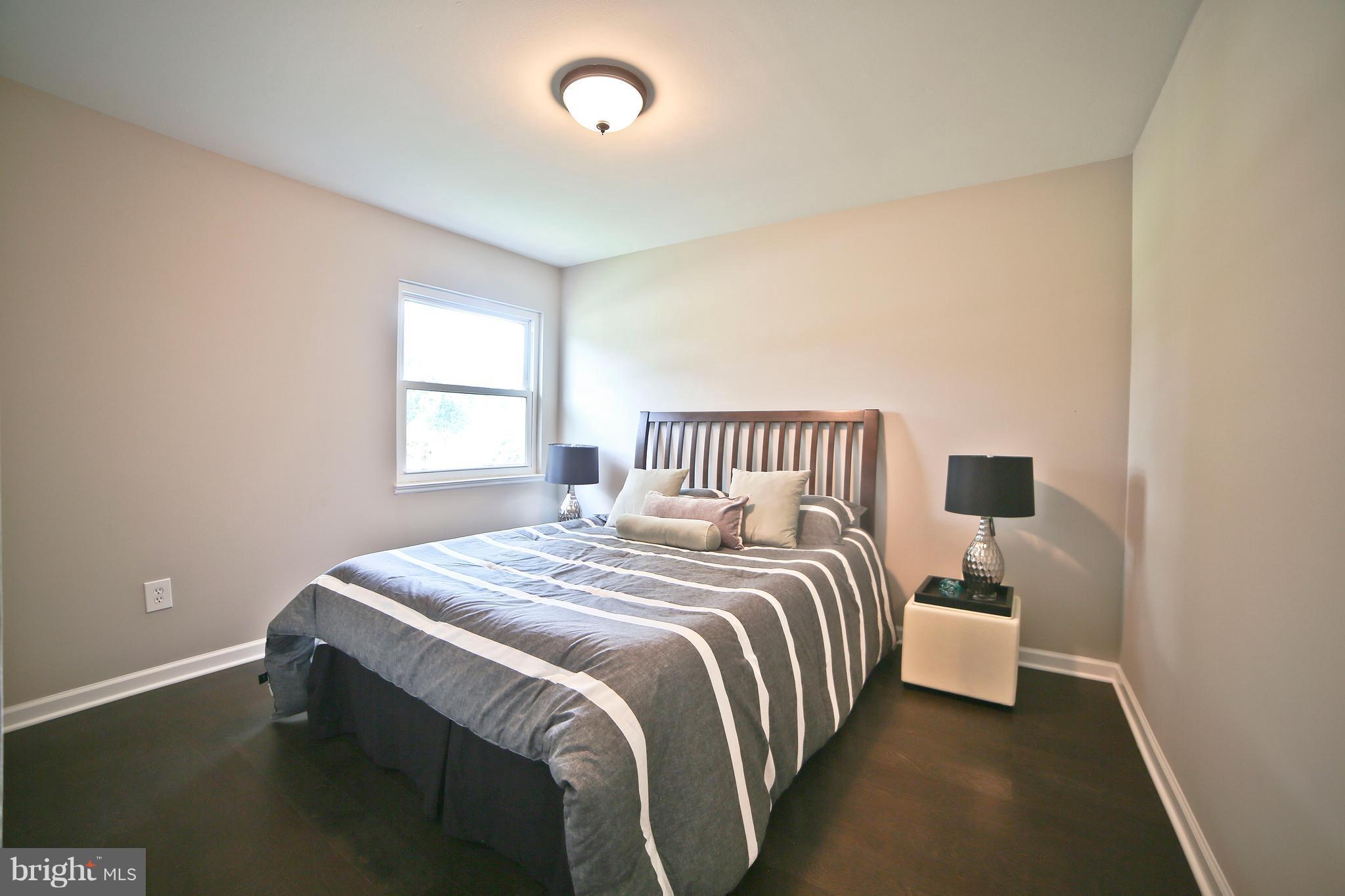 6612 Cimarron Street Springfield, VA 22150 - Photo 16 of 30 a bedroom with a bed and window