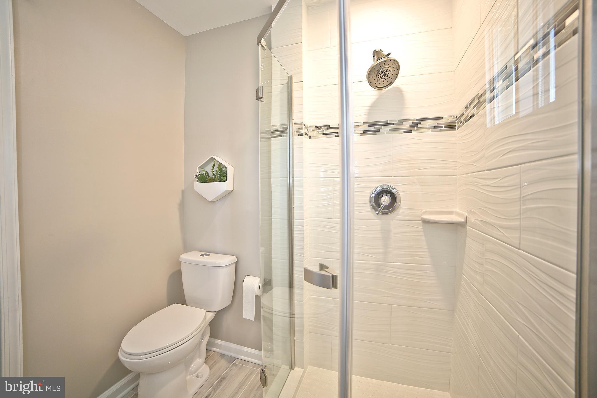 6612 Cimarron Street Springfield, VA 22150 - Photo 17 of 30 a bathroom with a toilet and a shower