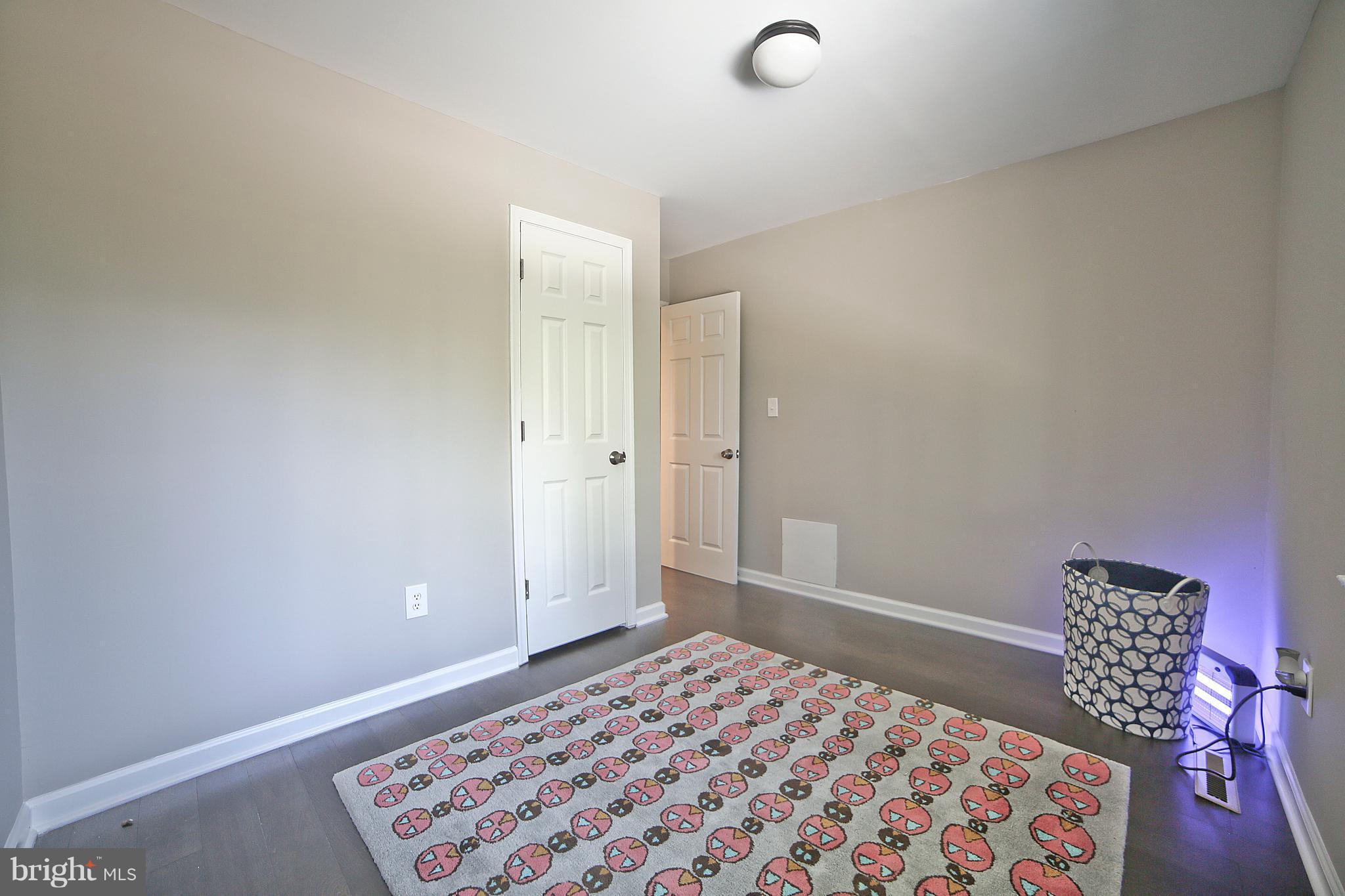 6612 Cimarron Street Springfield, VA 22150 - Photo 20 of 30 a bedroom with a bed and a lamp