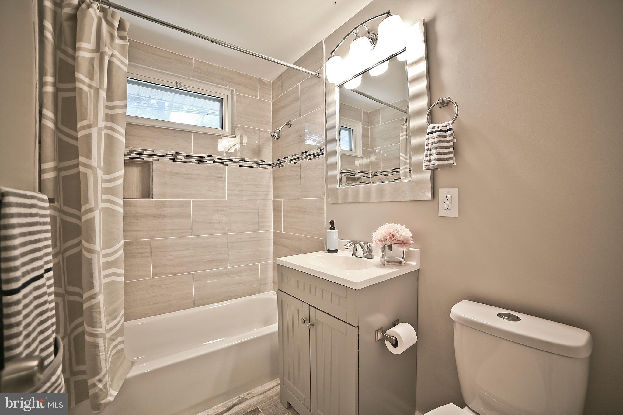 6612 Cimarron Street Springfield, VA 22150 - Photo 21 of 30 a bathroom with a sink a toilet and shower