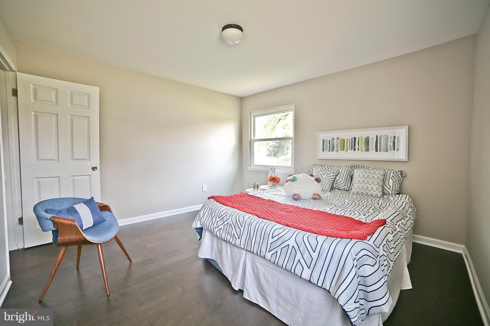 6612 Cimarron Street Springfield, VA 22150 - Photo 23 of 30 a bedroom with a bed and chair