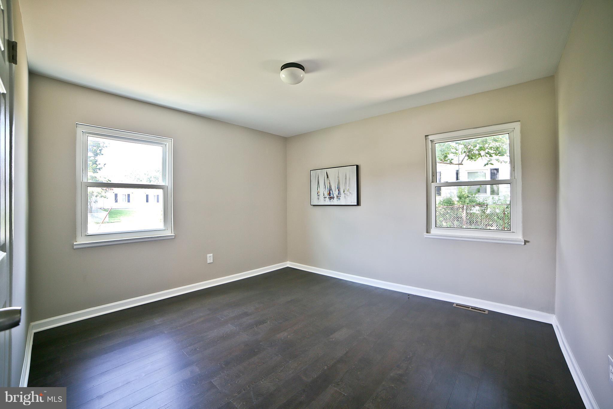 6612 Cimarron Street Springfield, VA 22150 - Photo 24 of 30 a view of an empty room with wooden floor and a window