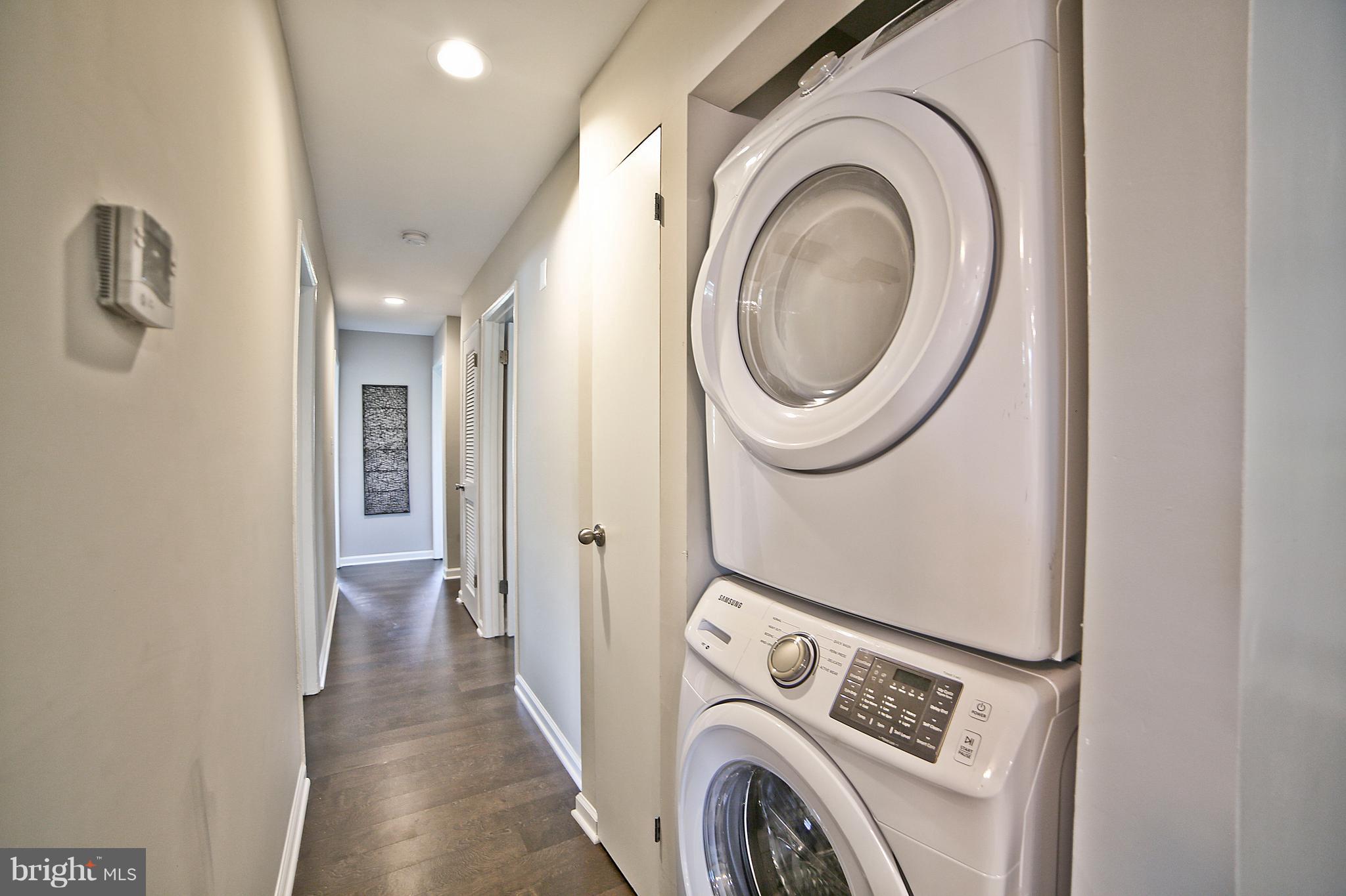 6612 Cimarron Street Springfield, VA 22150 - Photo 25 of 30 a view of a hallway with washer and dryer