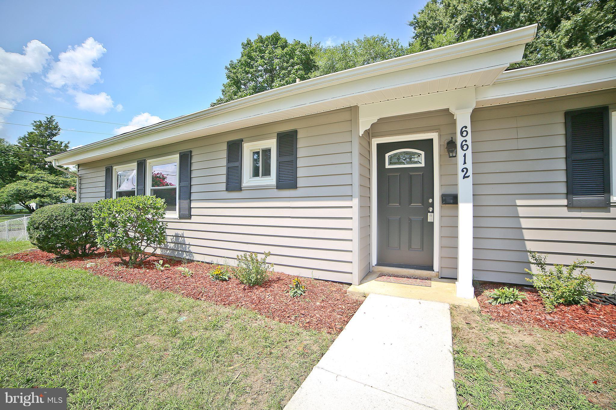 6612 Cimarron Street Springfield, VA 22150 - Photo 27 of 30 a front view of a house with garden