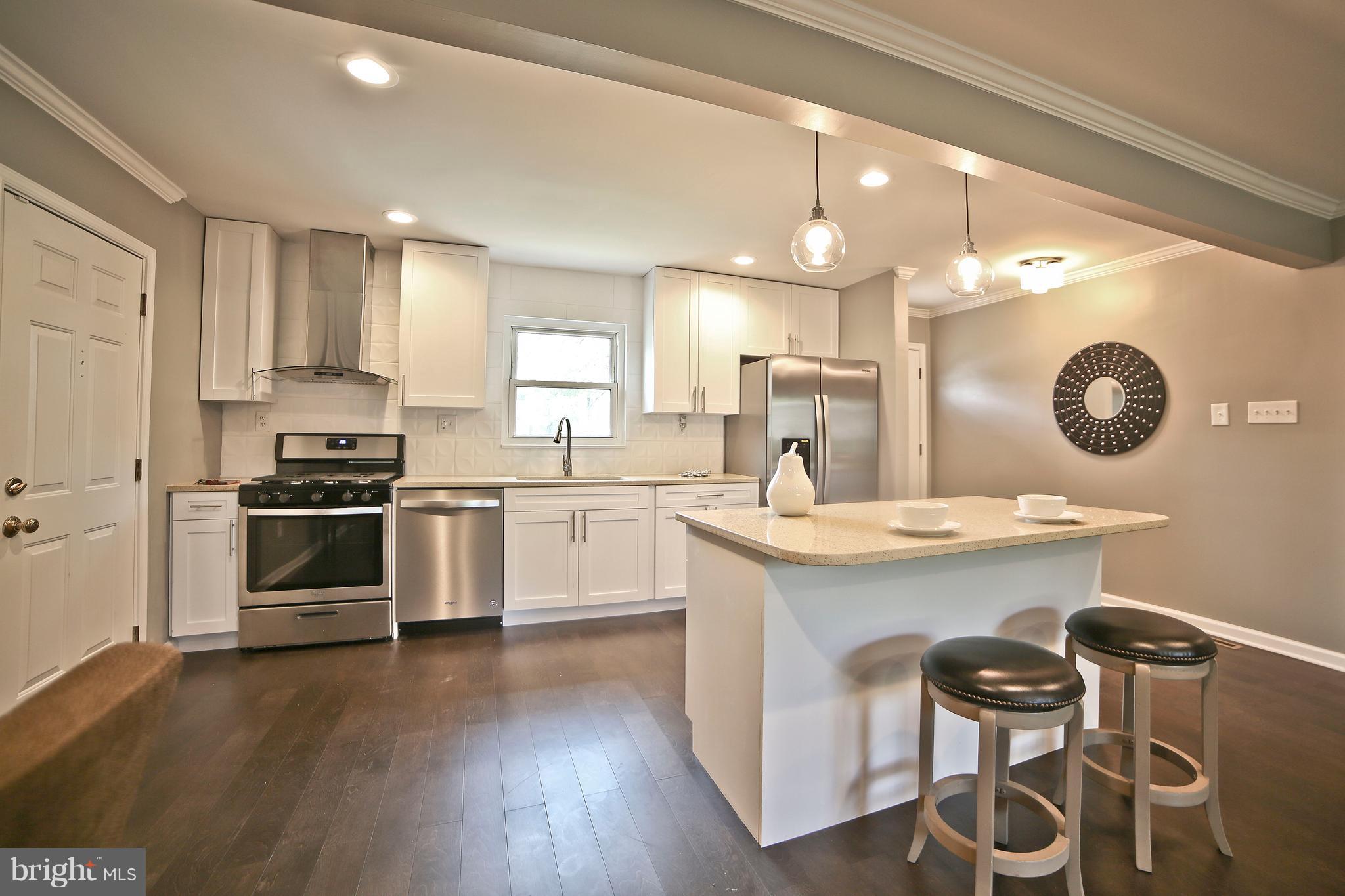 6612 Cimarron Street Springfield, VA 22150 - Photo 6 of 30 a kitchen with a sink cabinets and wooden floor