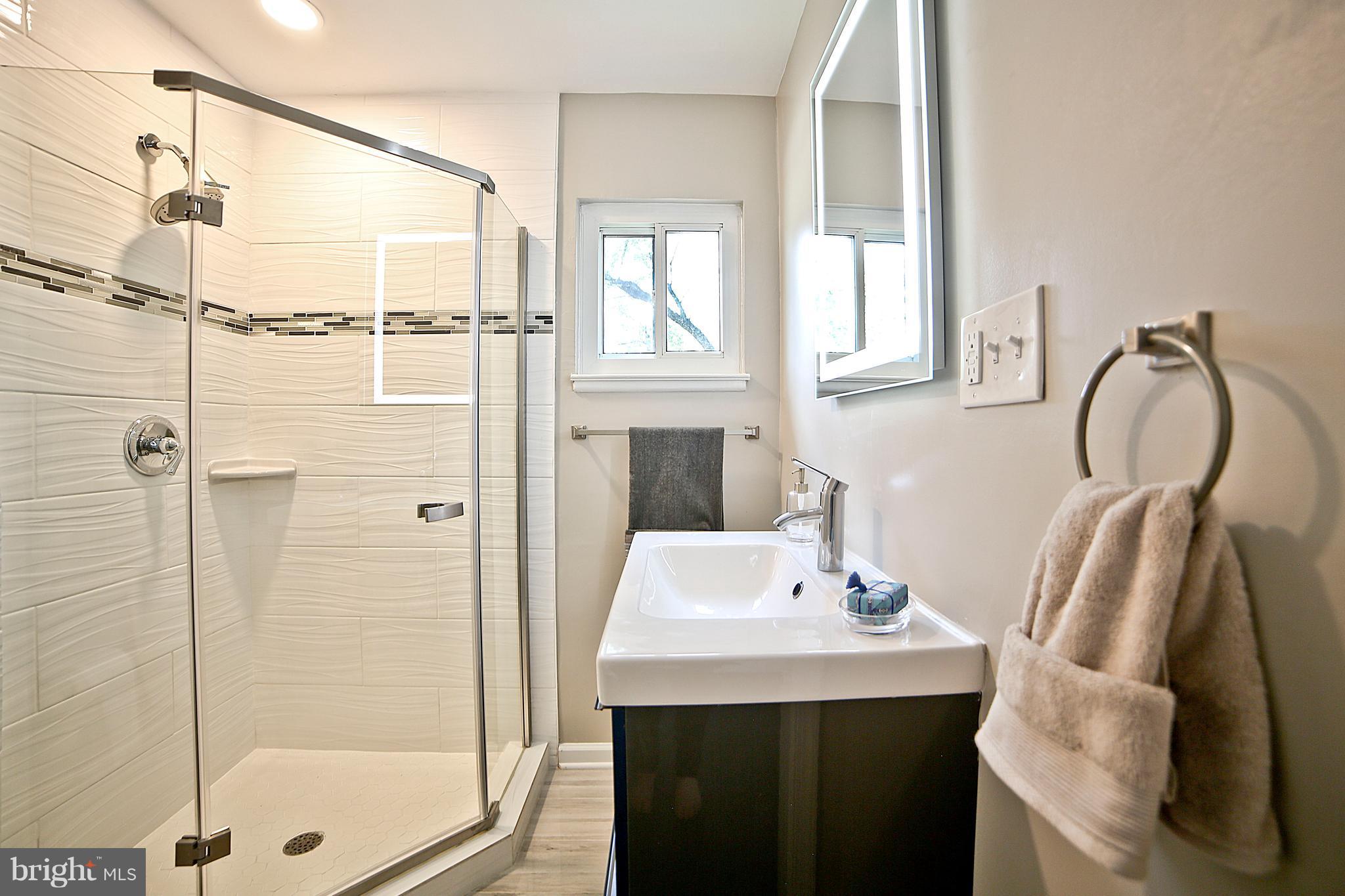 6612 Cimarron Street Springfield, VA 22150 - Photo 7 of 30 a bathroom with a sink and a mirror