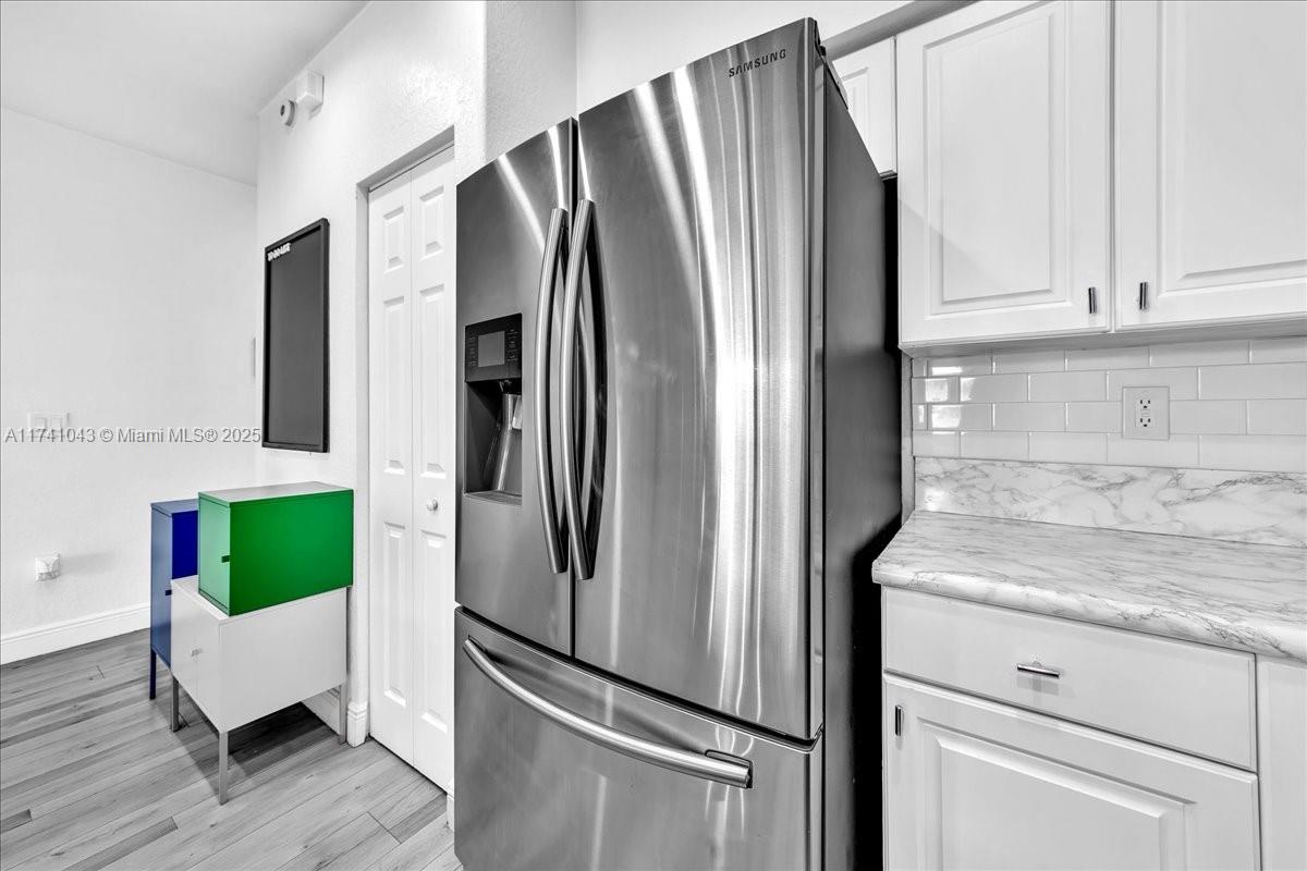 8381 Southwest 26 Th Street, Unit 103 Miramar, FL 33025 - Photo 17 of 62 a metallic refrigerator freezer sitting in a kitchen