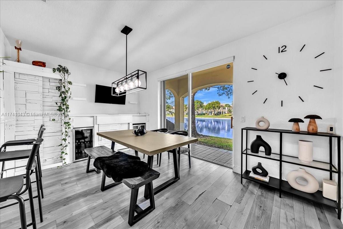 8381 Southwest 26 Th Street, Unit 103 Miramar, FL 33025 - Photo 22 of 62 a living room with furniture and a wooden floor