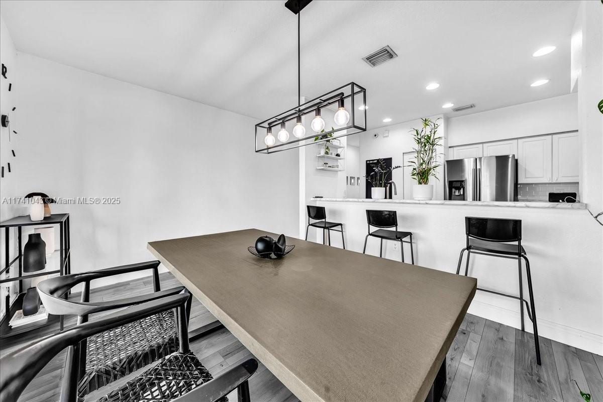 8381 Southwest 26 Th Street, Unit 103 Miramar, FL 33025 - Photo 27 of 62 a view of a dining room with furniture and wooden floor