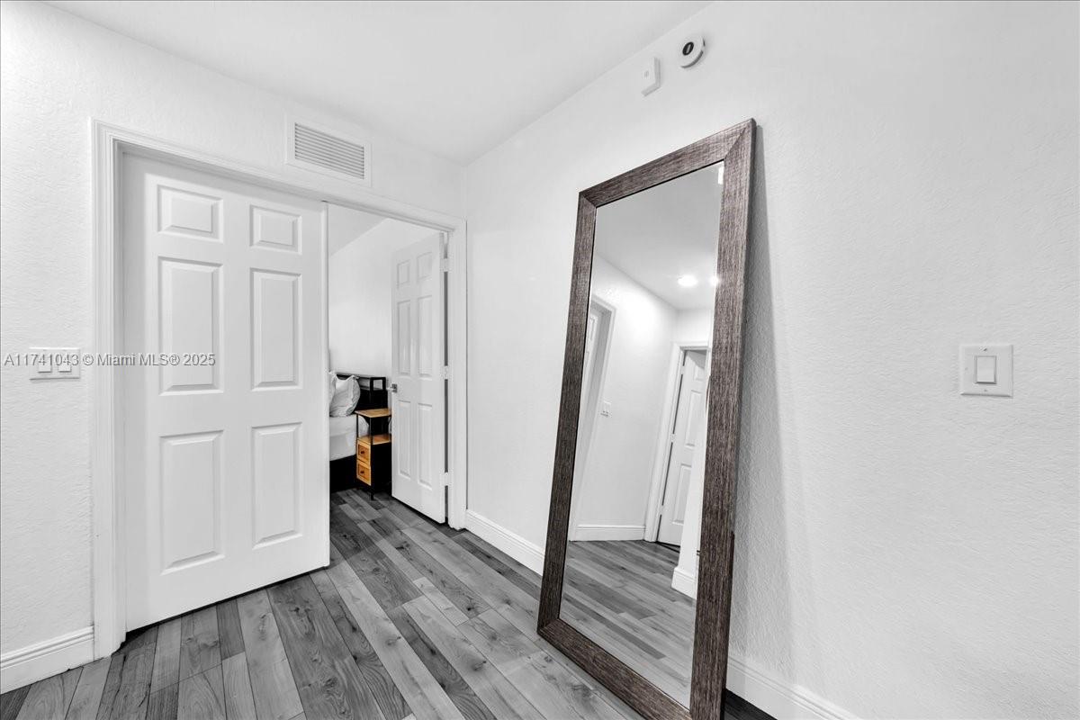 8381 Southwest 26 Th Street, Unit 103 Miramar, FL 33025 - Photo 29 of 62 a view of a hallway with wooden floor