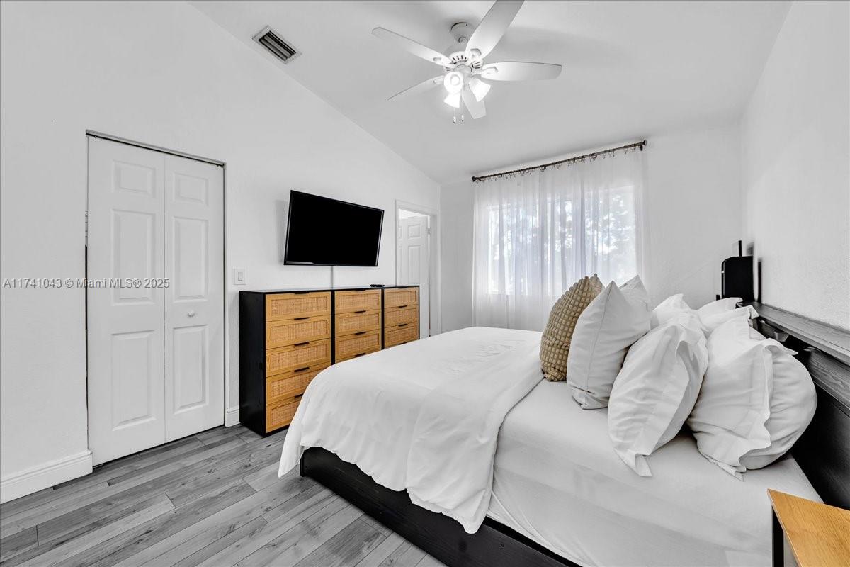 8381 Southwest 26 Th Street, Unit 103 Miramar, FL 33025 - Photo 30 of 62 a bedroom with a bed and a flat screen tv