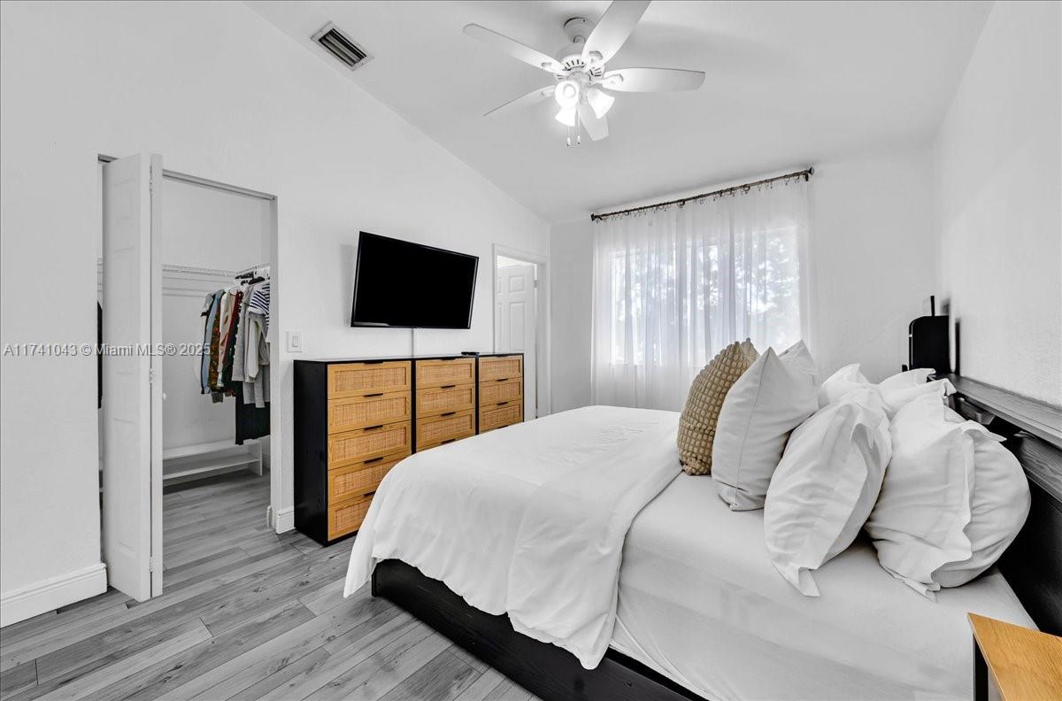 8381 Southwest 26 Th Street, Unit 103 Miramar, FL 33025 - Photo 31 of 62 a bedroom with a bed and a flat screen tv