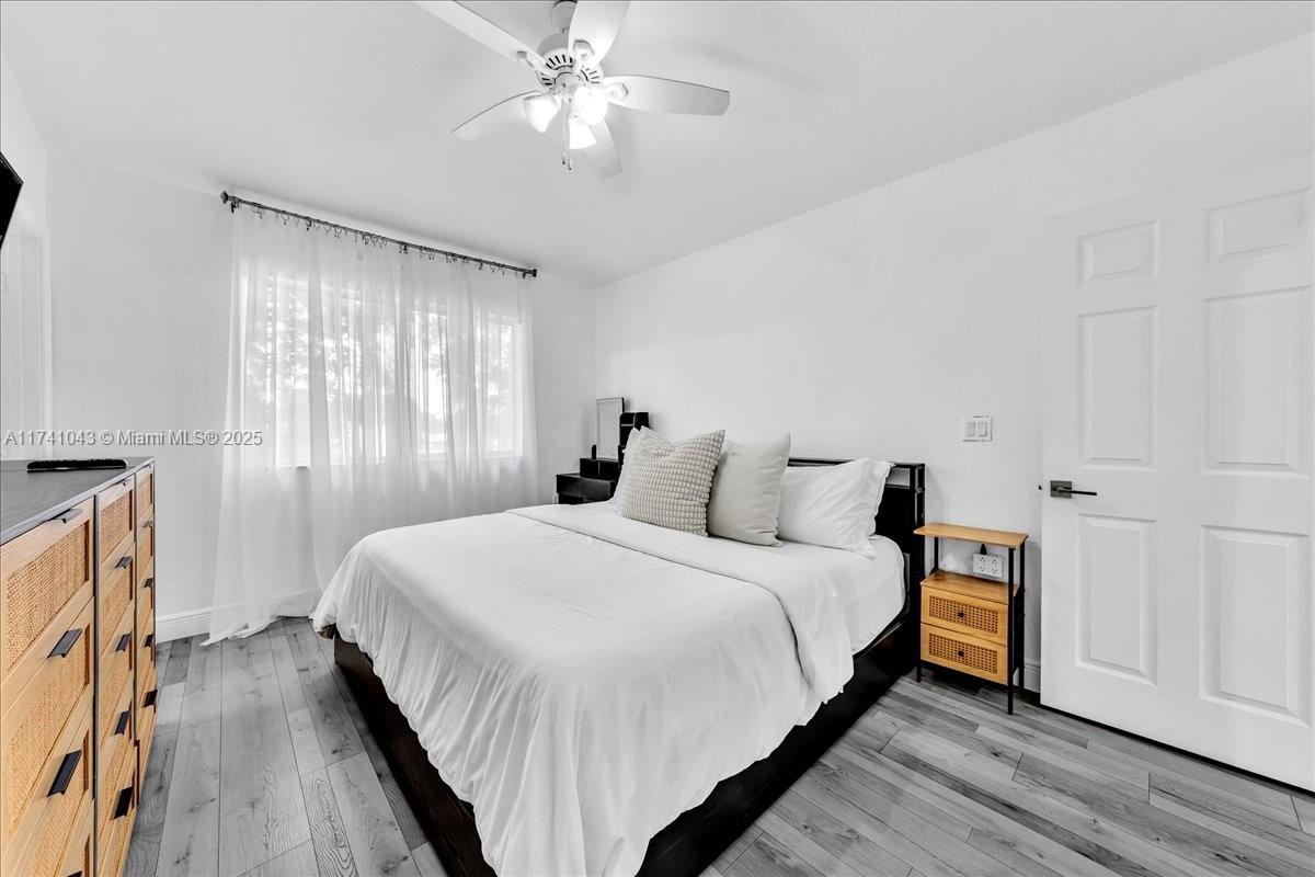 8381 Southwest 26 Th Street, Unit 103 Miramar, FL 33025 - Photo 32 of 62 a bedroom with bed and a chandelier