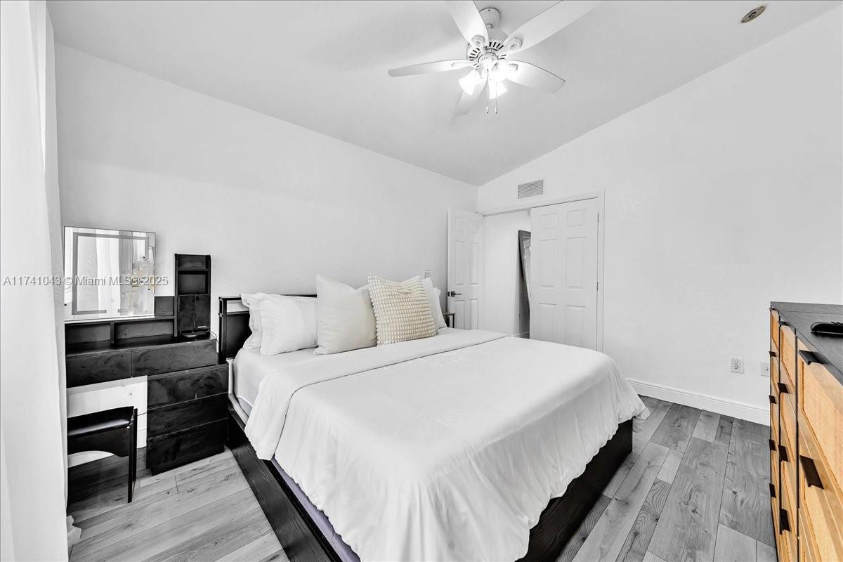 8381 Southwest 26 Th Street, Unit 103 Miramar, FL 33025 - Photo 33 of 62 a bedroom with bed and wooden floor