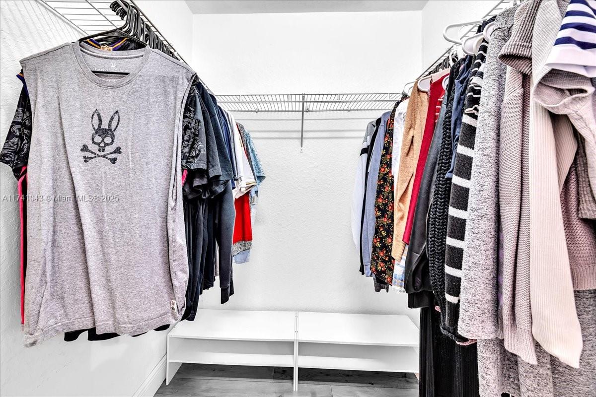 8381 Southwest 26 Th Street, Unit 103 Miramar, FL 33025 - Photo 35 of 62 a view of walk in closet with clothes and shoes