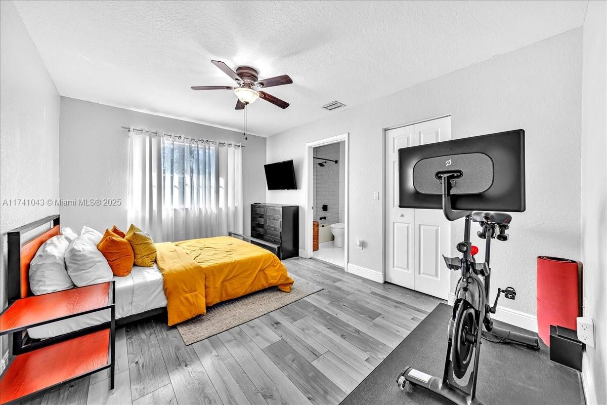 8381 Southwest 26 Th Street, Unit 103 Miramar, FL 33025 - Photo 36 of 62 a bedroom with furniture and a flat screen tv