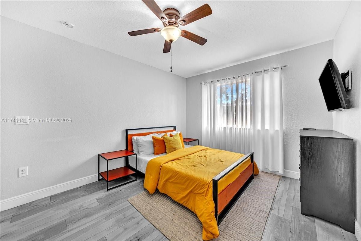 8381 Southwest 26 Th Street, Unit 103 Miramar, FL 33025 - Photo 37 of 62 a bedroom with a bed and a flat screen tv