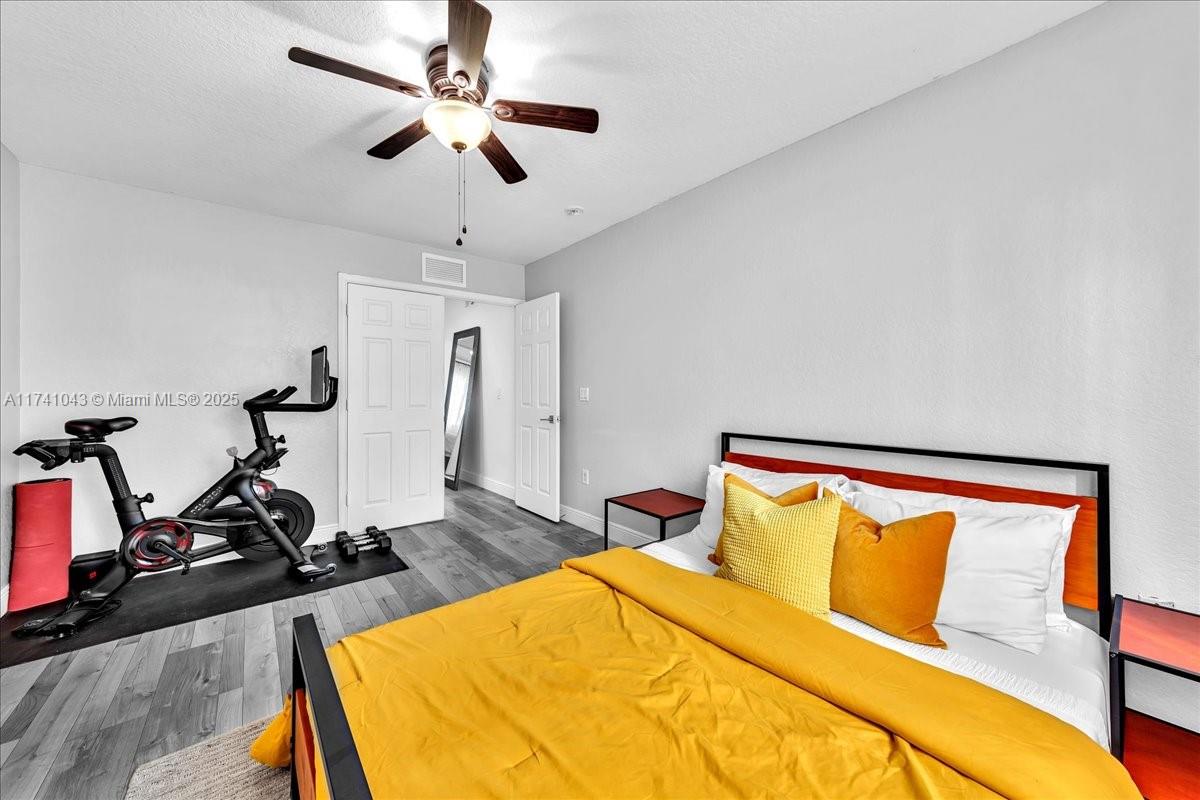 8381 Southwest 26 Th Street, Unit 103 Miramar, FL 33025 - Photo 38 of 62 a bedroom with a bed and wooden floor