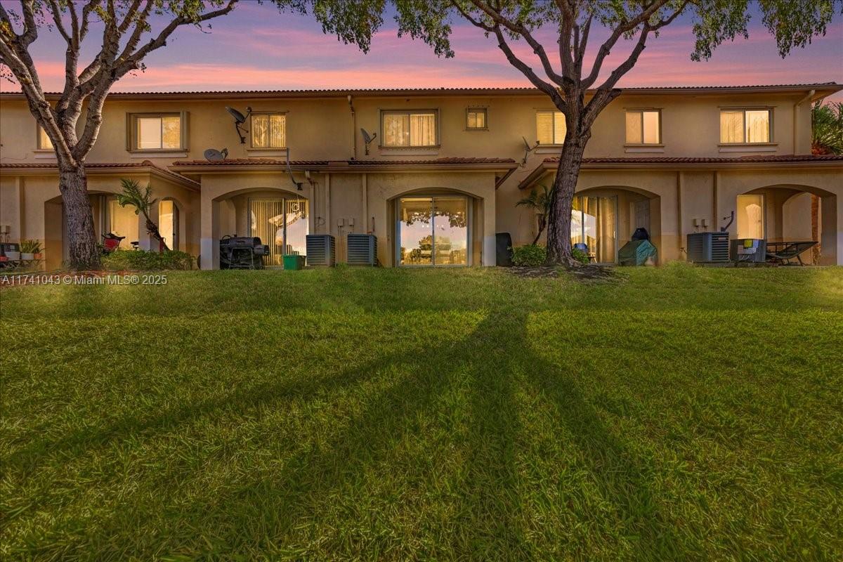 8381 Southwest 26 Th Street, Unit 103 Miramar, FL 33025 - Photo 46 of 62 a front view of a residential houses with yard and play ground