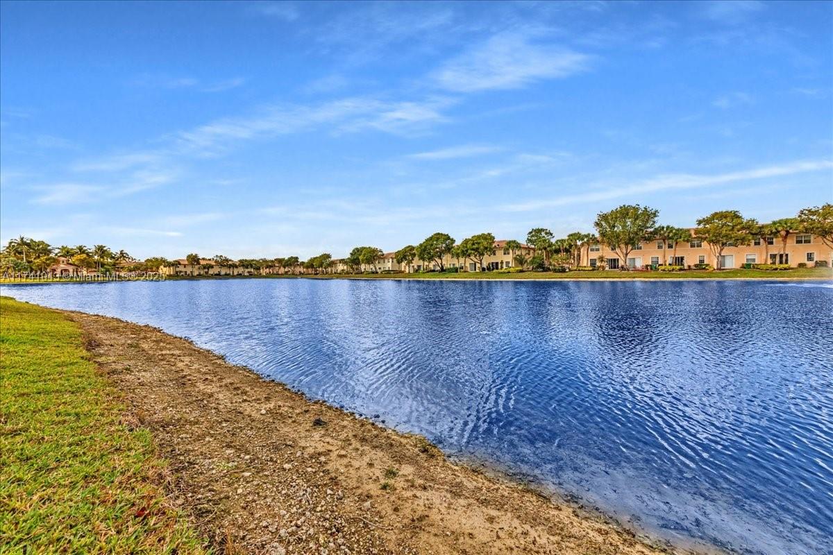 8381 Southwest 26 Th Street, Unit 103 Miramar, FL 33025 - Photo 50 of 62 a view of a lake with houses in the back