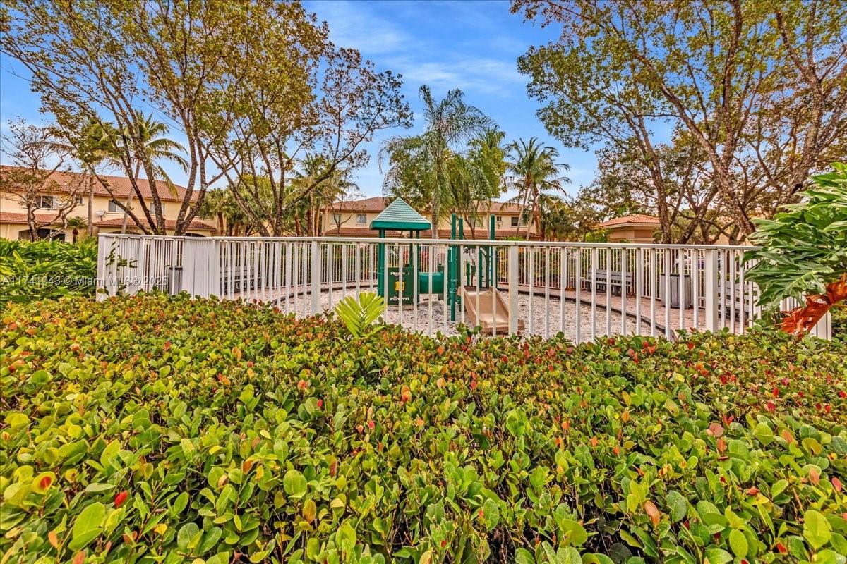 8381 Southwest 26 Th Street, Unit 103 Miramar, FL 33025 - Photo 62 of 62 a view of a garden with wooden fence