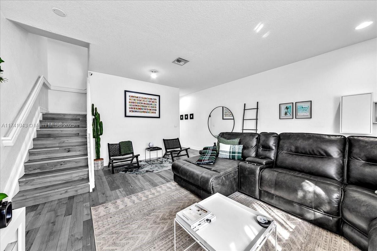 8381 Southwest 26 Th Street, Unit 103 Miramar, FL 33025 - Photo 8 of 62 a living room with furniture and stairs