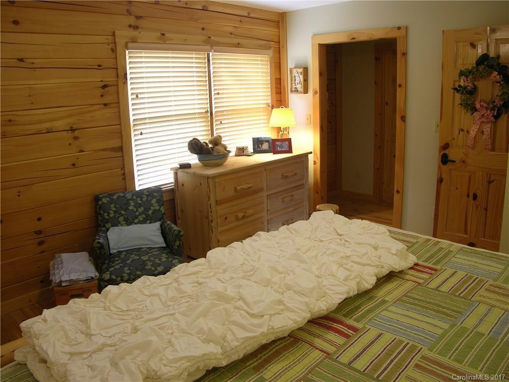 145 Spring Hill Ln Mill Spring, Unit 32 Mill Spring, NC 28756 - Photo 13 of 24 a bedroom with a bed and a window