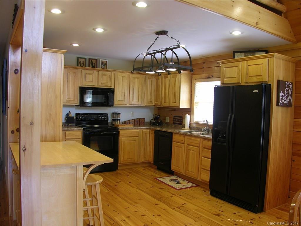 145 Spring Hill Ln Mill Spring, Unit 32 Mill Spring, NC 28756 - Photo 7 of 24 a kitchen with a refrigerator a stove a sink and a microwave