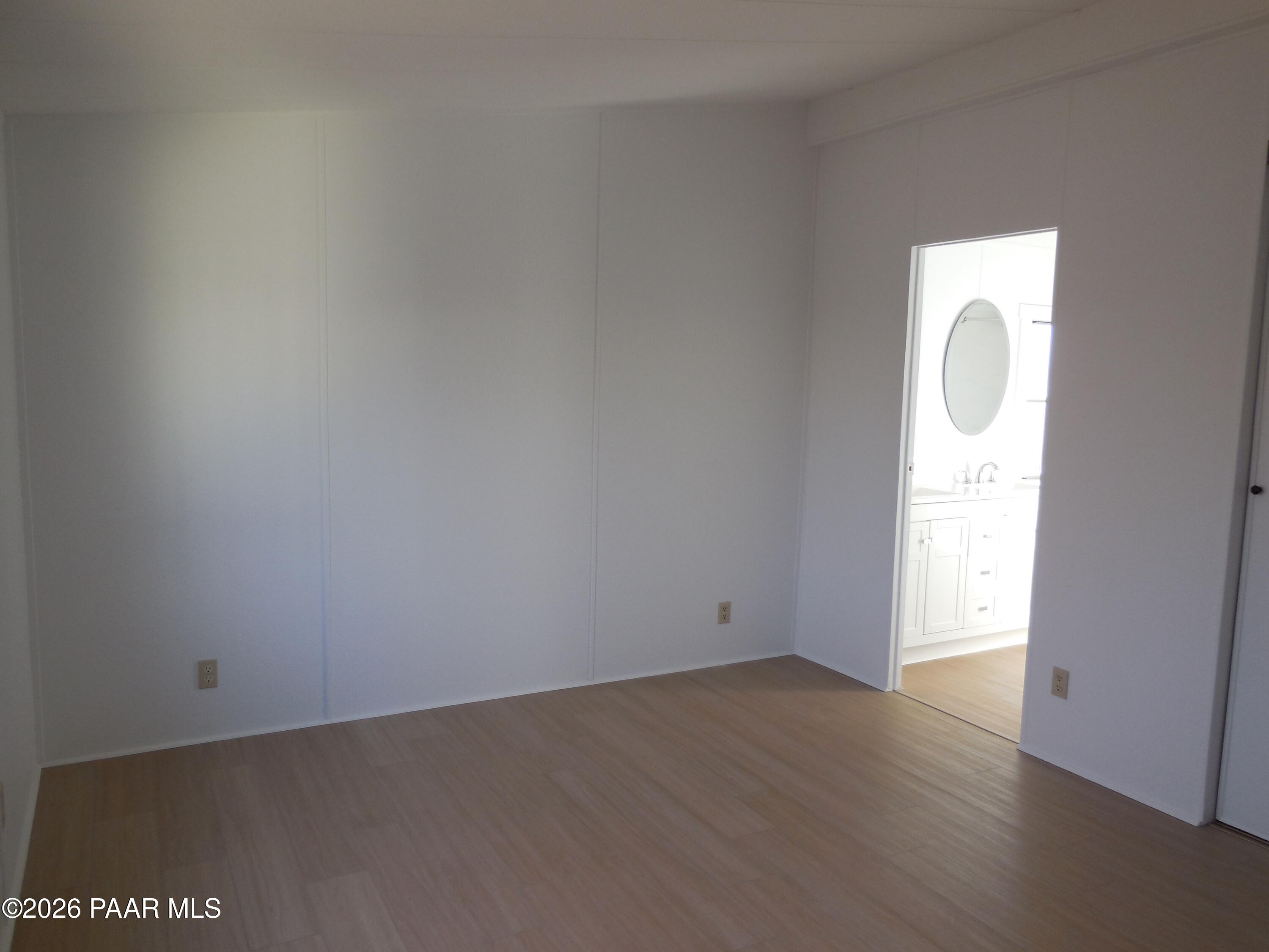 1145 Trinity Court Prescott, AZ 86301 - Photo 17 of 23 an empty room with wooden floor and windows