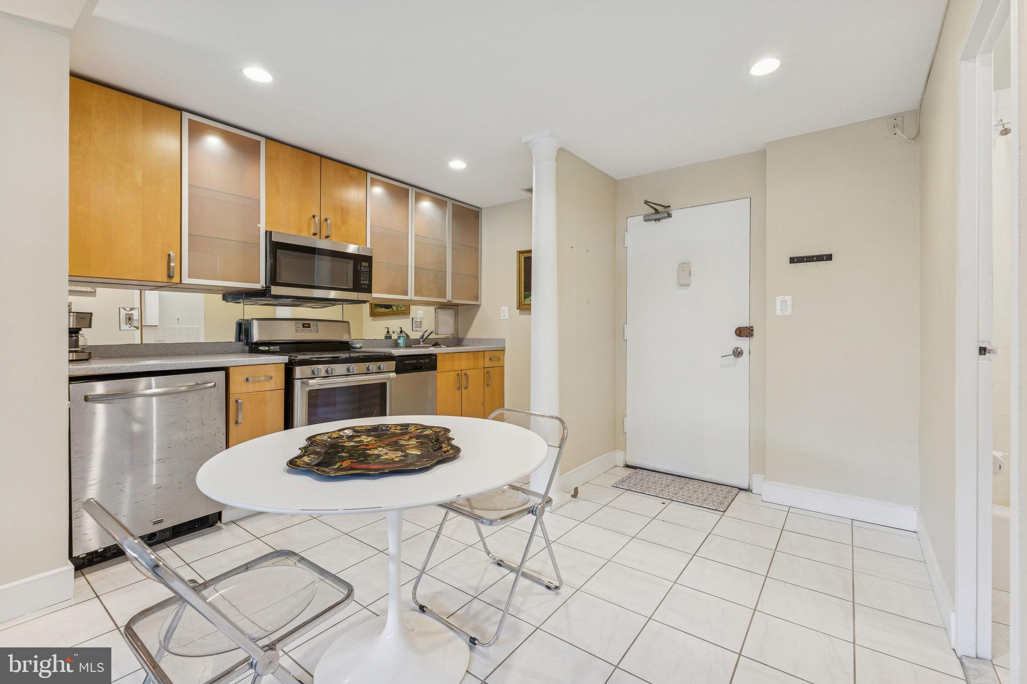 2829 Connecticut Avenue Northwest, Unit 107 Washington, DC 20008 - Photo 4 of 13 a kitchen with stainless steel appliances a stove a sink a microwave a refrigerator and cabinets