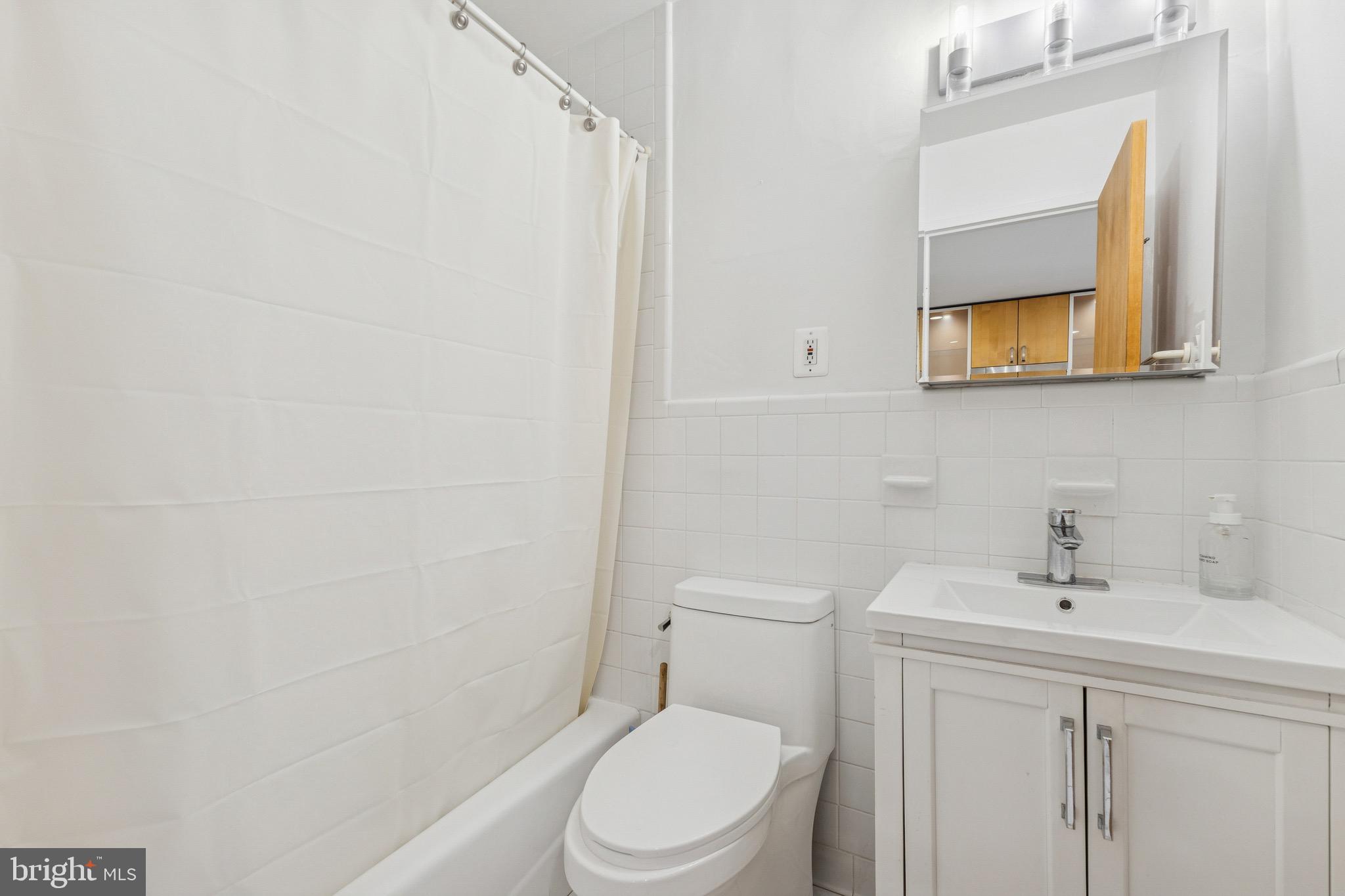 2829 Connecticut Avenue Northwest, Unit 107 Washington, DC 20008 - Photo 8 of 13 a white toilet sitting next to a bathroom sink