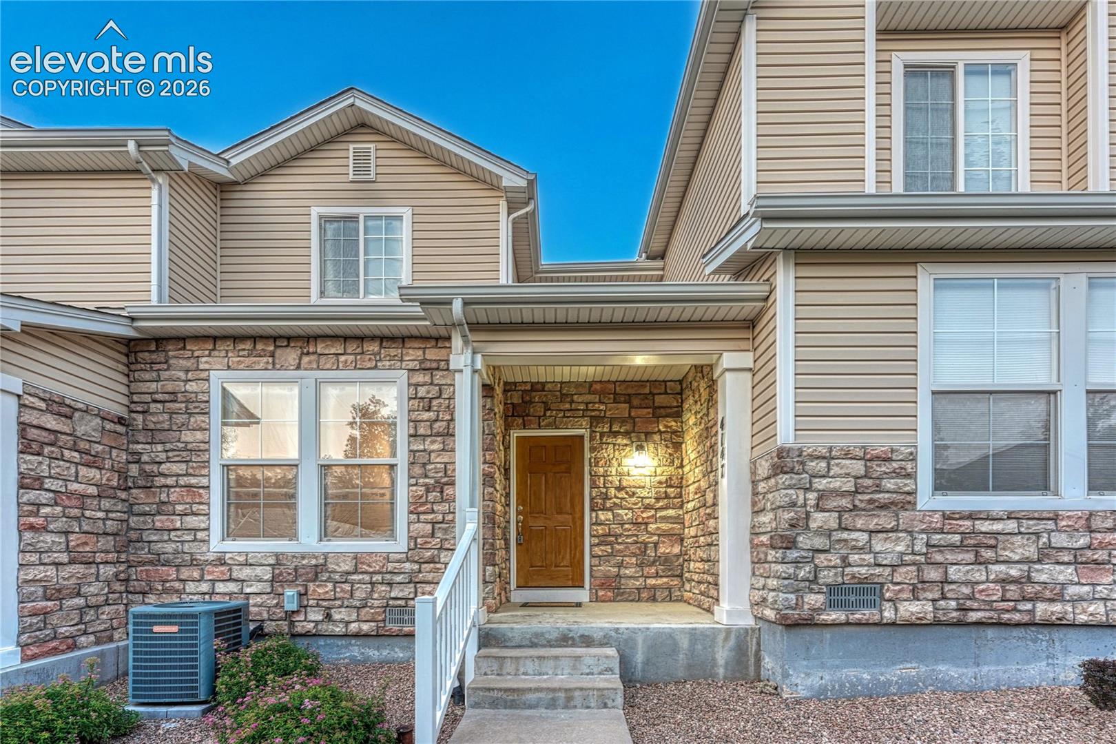 4147 Diamond Ridge View Colorado Springs, CO 80918 - Photo 37 of 42 Warm exterior lighting and beautiful stonework welcome you home to a peaceful cul-de-sac location