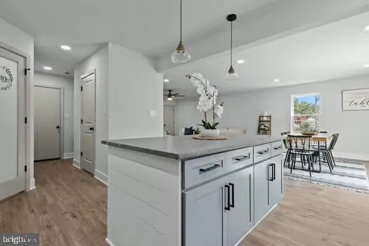 a kitchen with stainless steel appliances granite countertop a sink stove and wooden floor