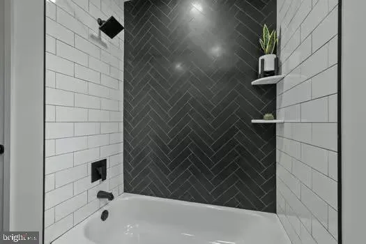 a bathroom with a bathtub and shower