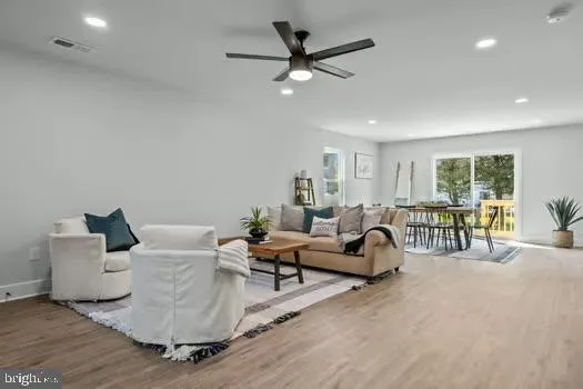 a living room with furniture and a large window with wooden floor
