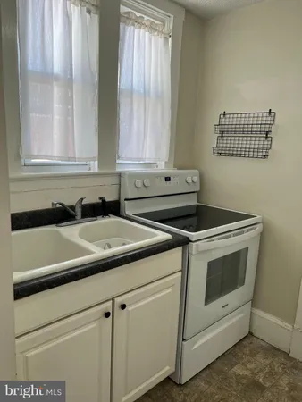 a view of a sink and a stove top oven