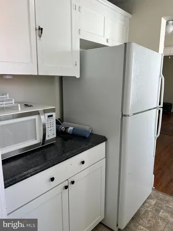 a white refrigerator freezer sitting inside of a kitchen